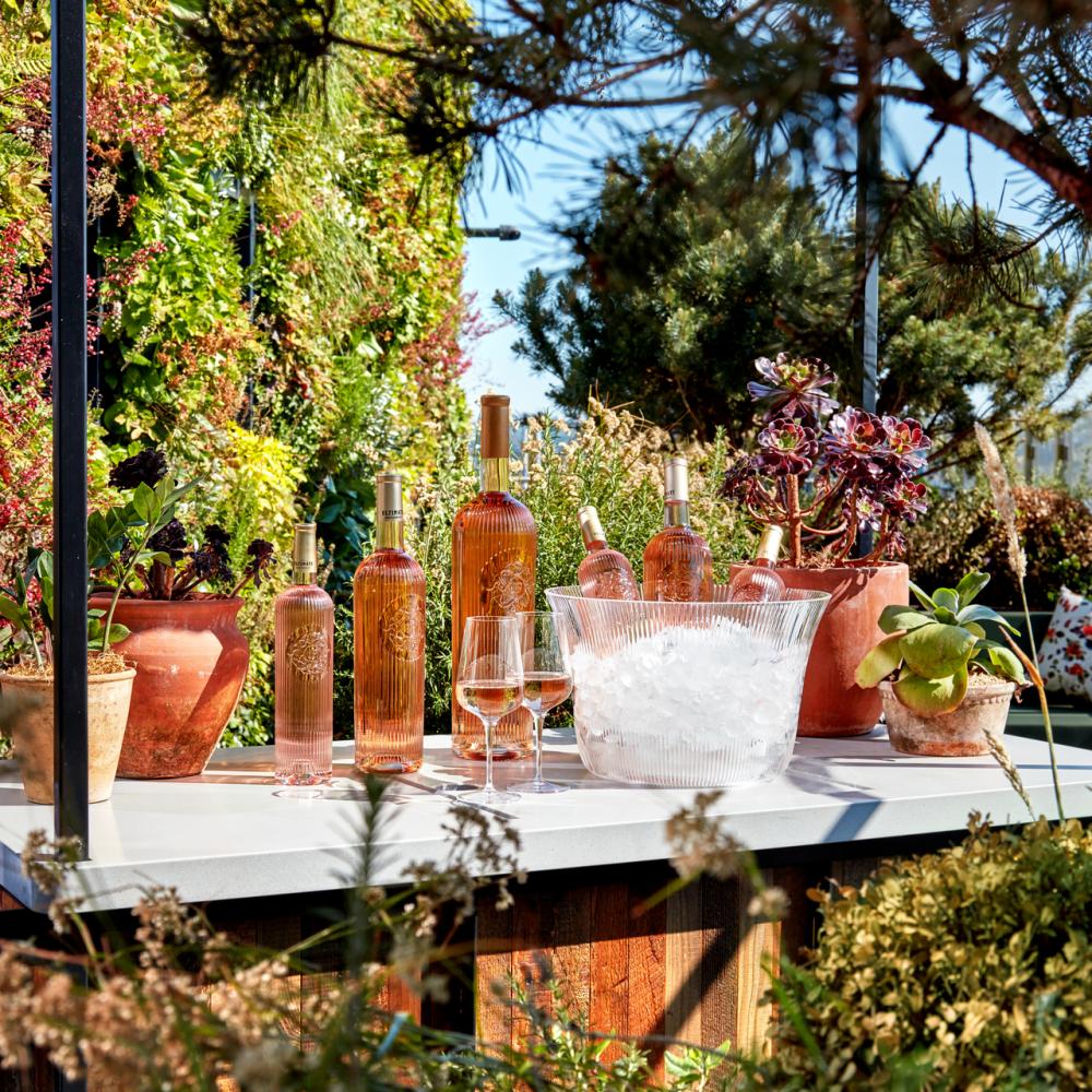 Outside bar with bottles of wine and a bucket of ice