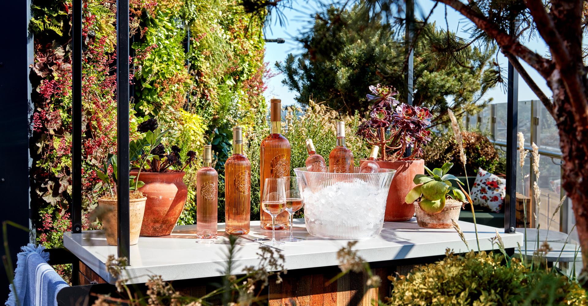 Outside bar with bottles of wine and a bucket of ice