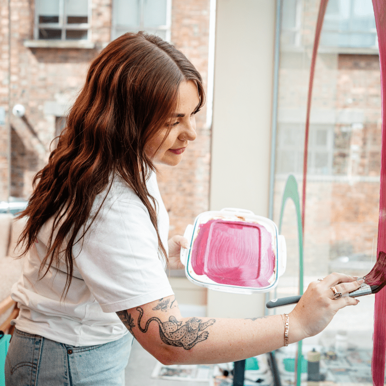 A woman painting a window
