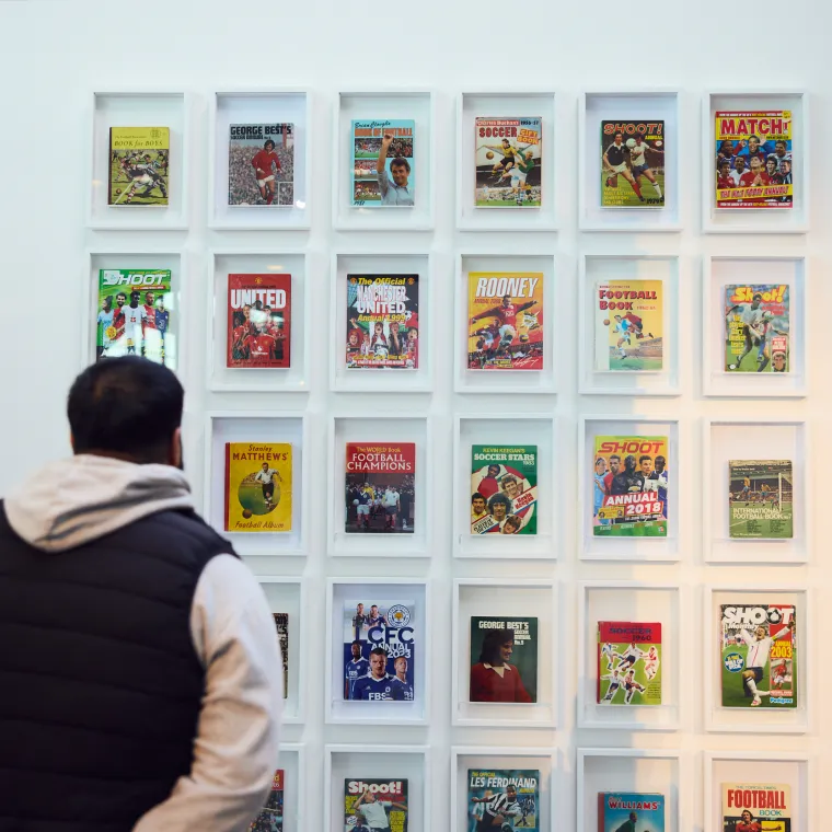 man looking at football magazines