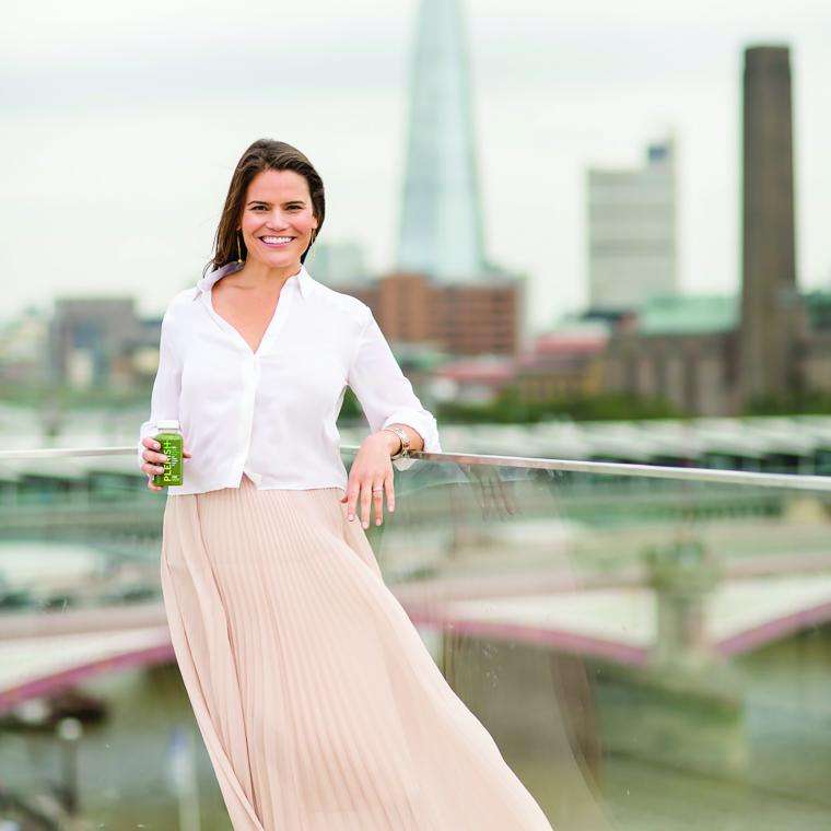 Karen Rosen holding a bottle of Plenish