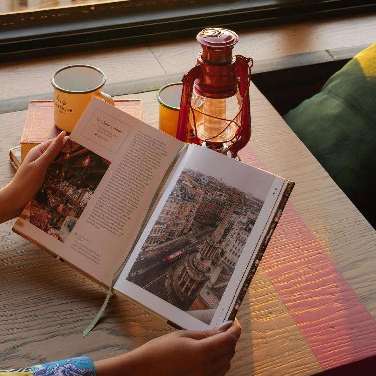 Woman reading Pretty Little London book
