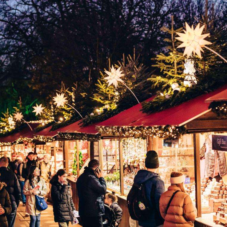 people at a Christmas market at night
