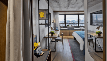 Entry way to hotel room with wardrobe and bench