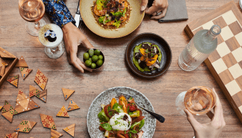 People playing card games and enjoying food
