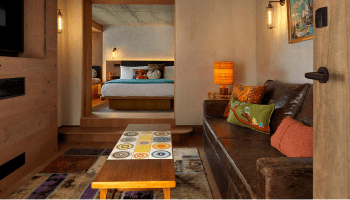 seating area with long table and wide doorway to bedroom