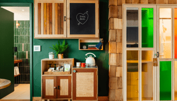 Hotel room with green walls and wood decor