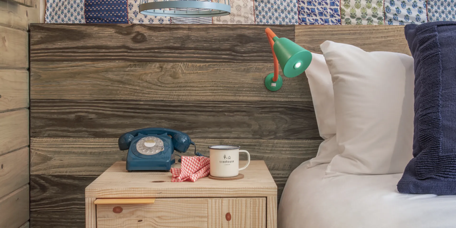 nightside table with blue phone and white mug